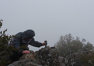 Setting timelapse cameras in storm atop Mt Kaputar